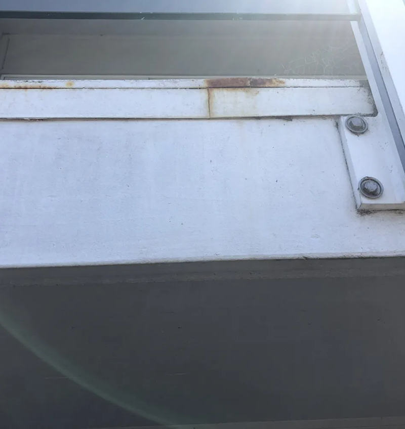 A close up of a metal roof with rust on it.