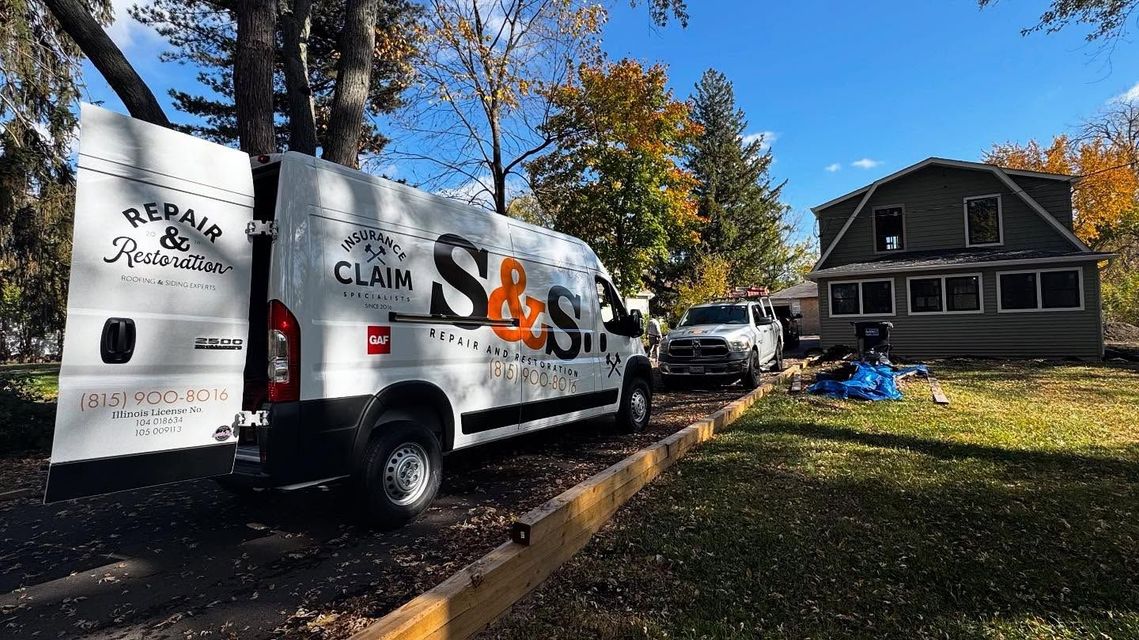 A white van is parked in front of a house.