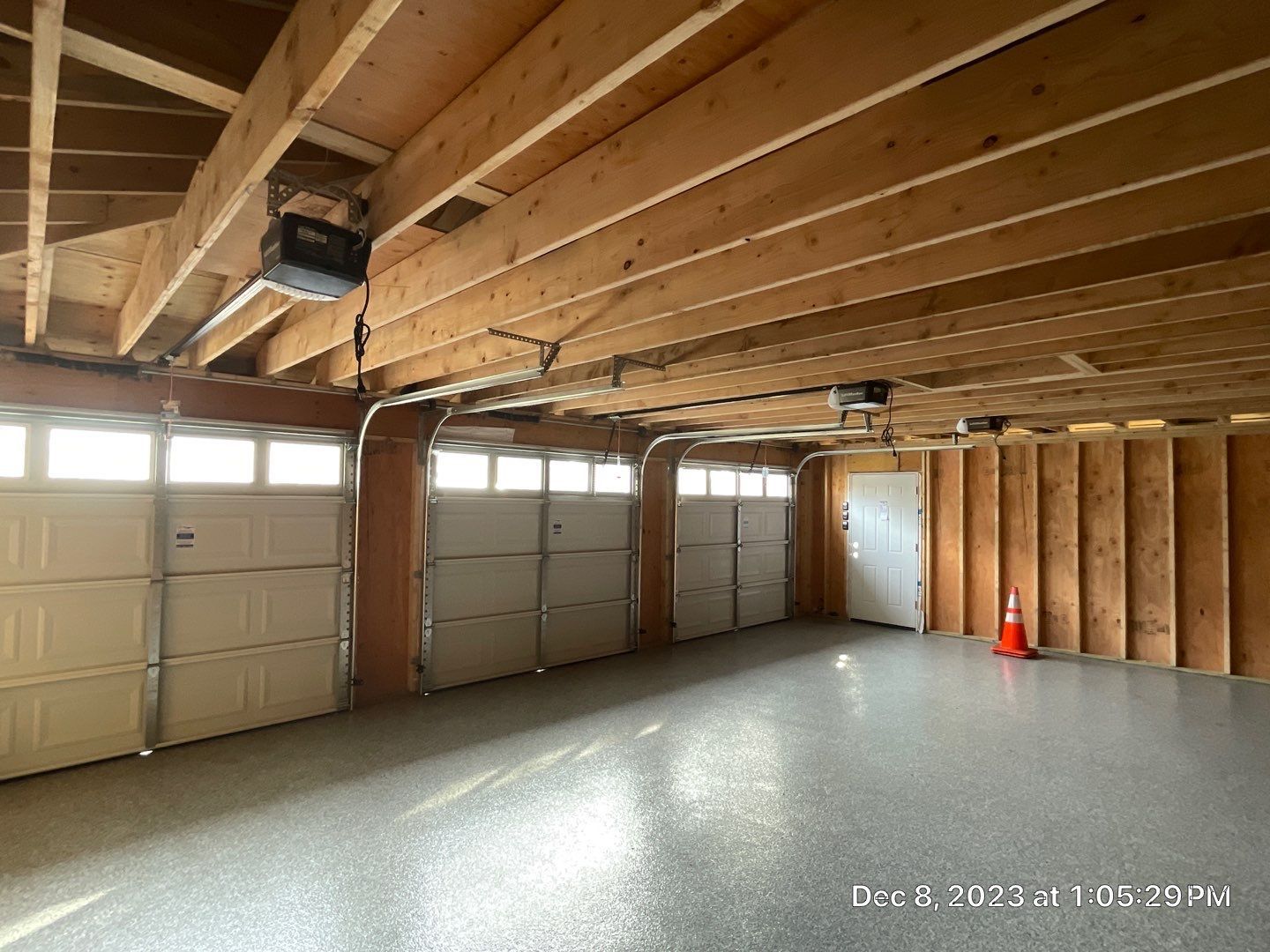 A garage with a lot of doors and a ceiling that is being built.