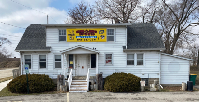 A white house with a yellow sign on the front of it.