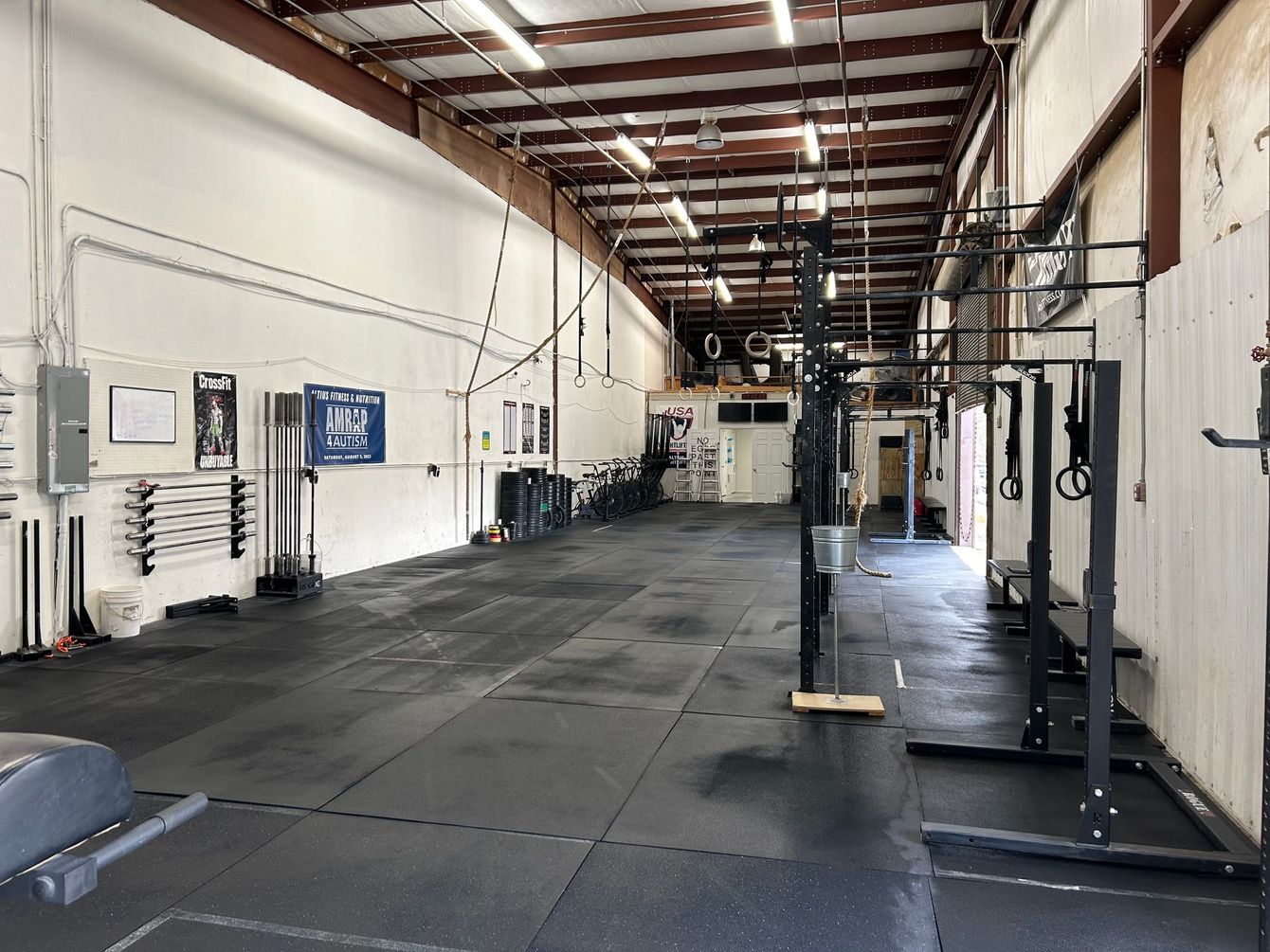 A large empty gym with a lot of equipment.