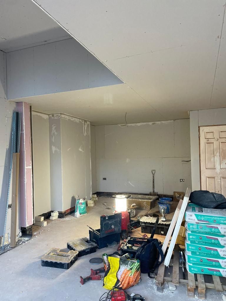 A room under construction with a lot of tools on the floor.