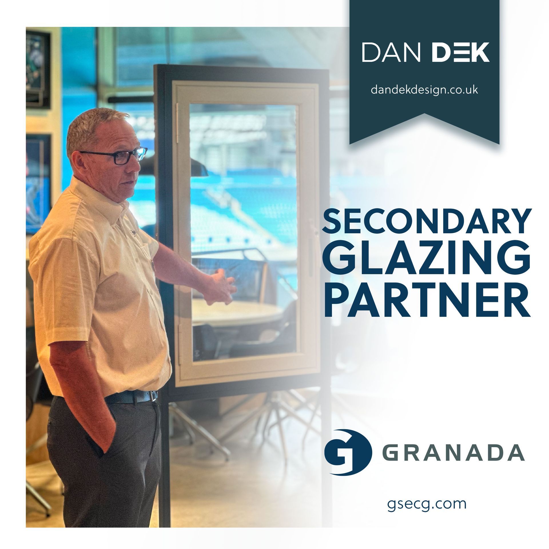 A man is standing in front of a window and a sign that says secondary glazing partner