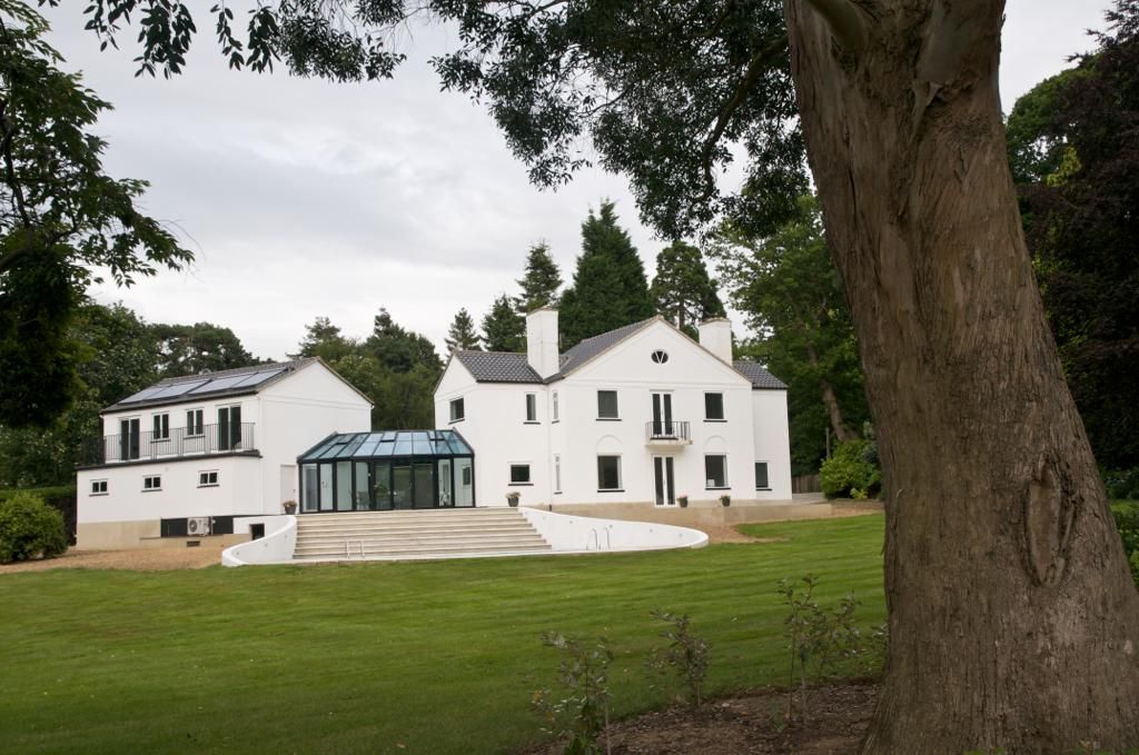 A large white house with a tree in front of it
