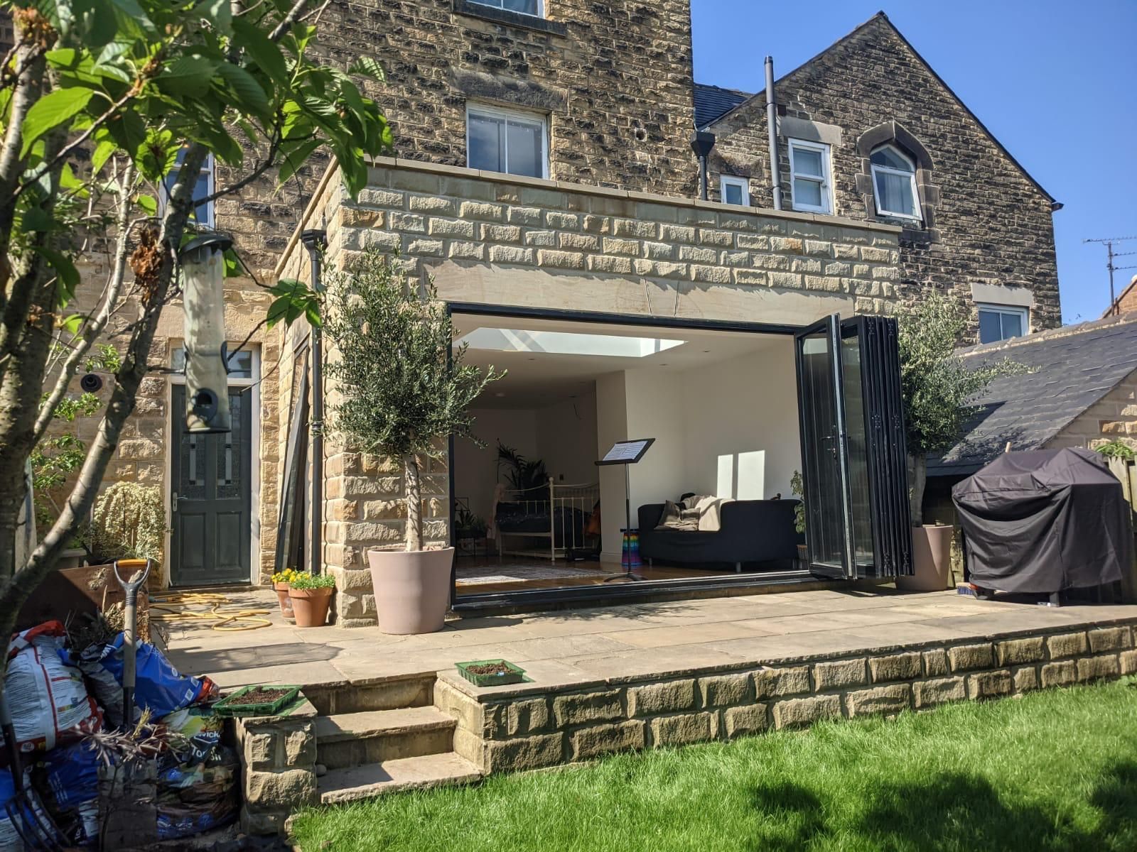 A large brick house with a patio in front of it.