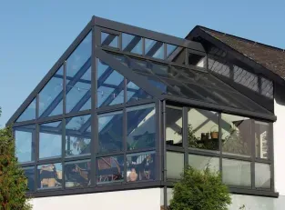 A house with a glass roof and a lot of windows.