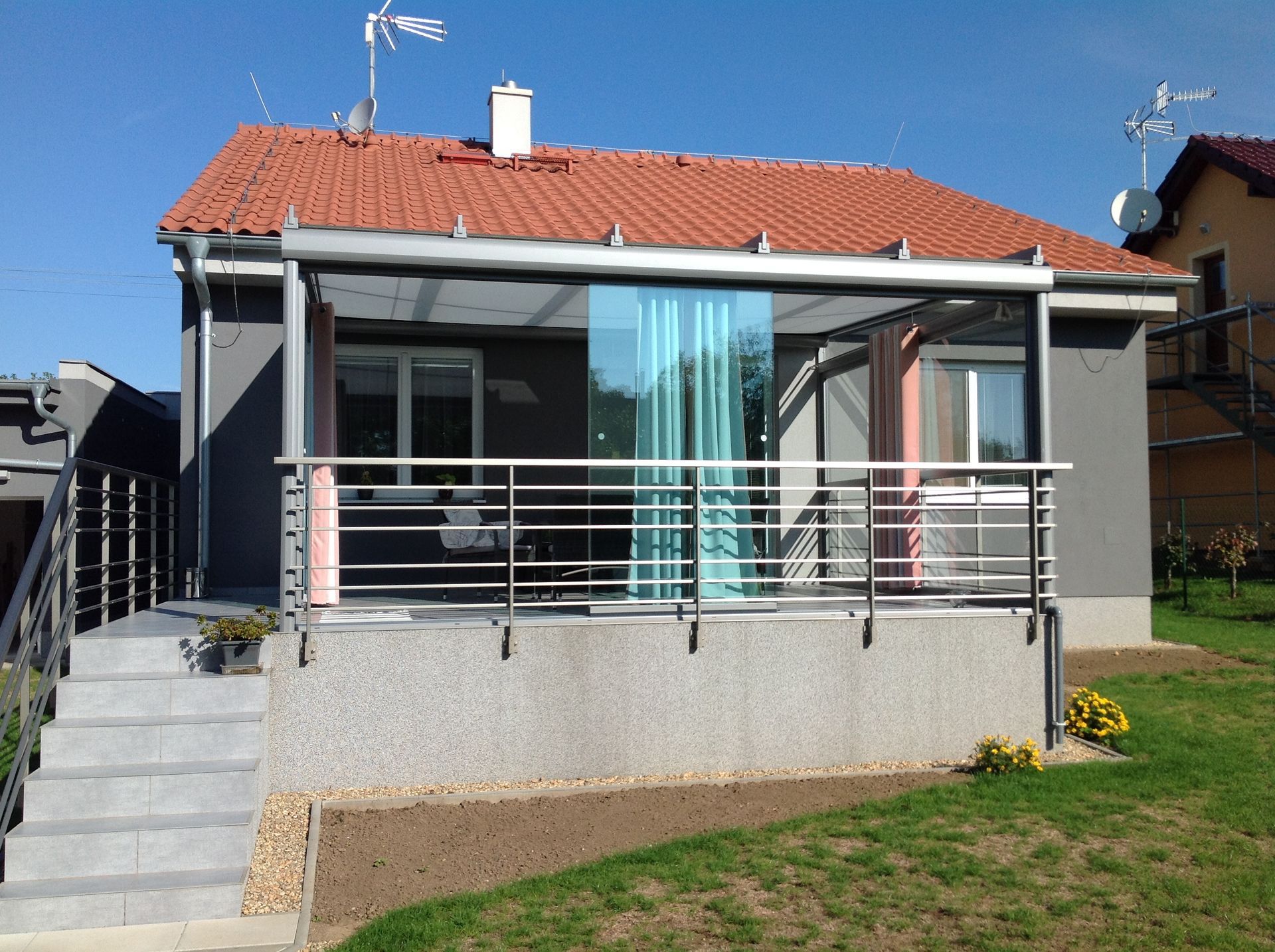 A house with a balcony and stairs in front of it
