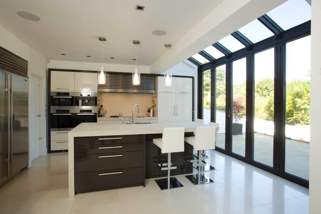A kitchen with a large island and lots of windows
