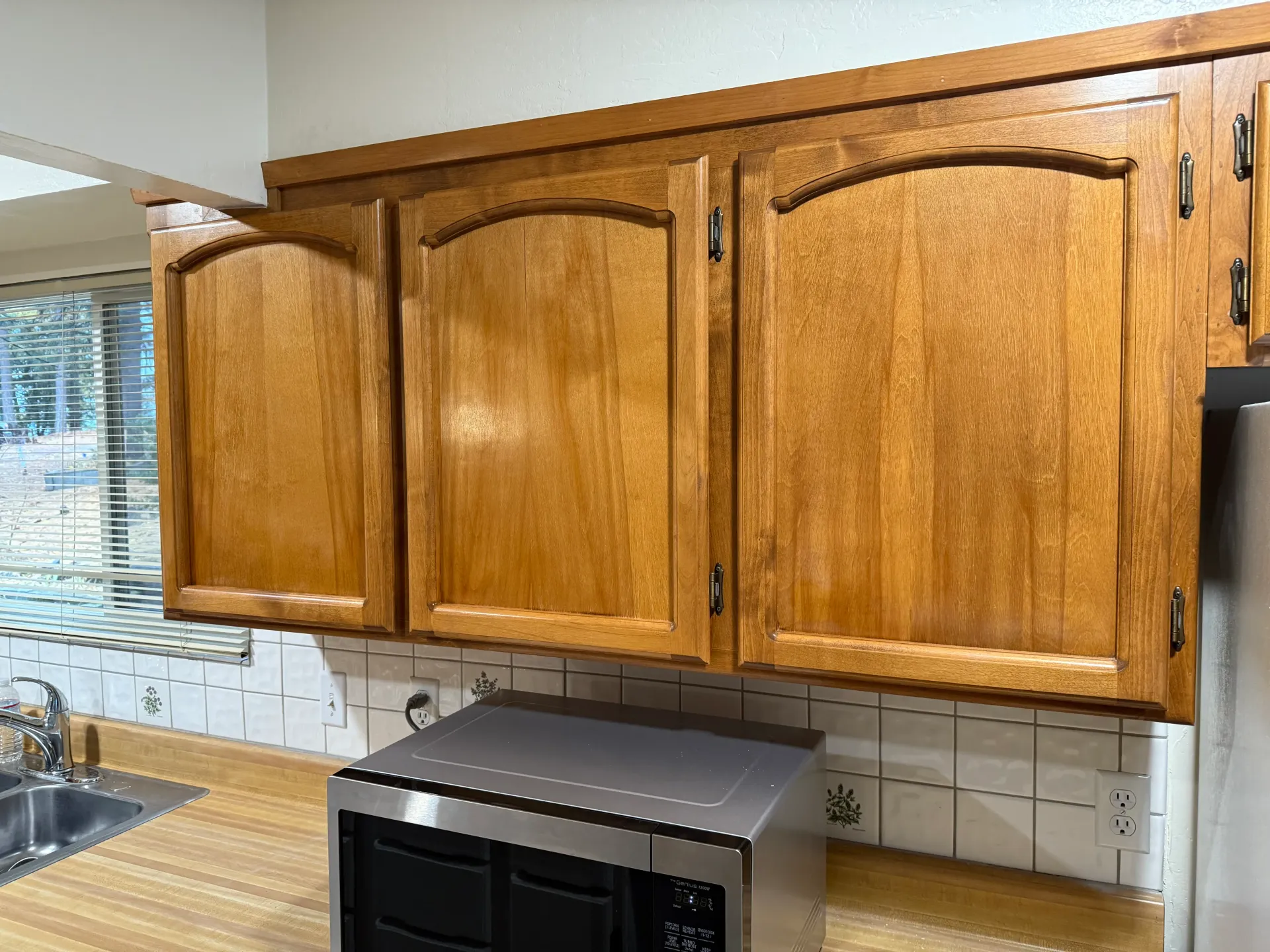 A kitchen with stainless steel appliances and wooden cabinets
