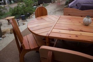 Wooden patio table and chairs in an outdoor garden setting