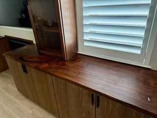 A kitchen with wooden cabinets and a stainless steel dishwasher