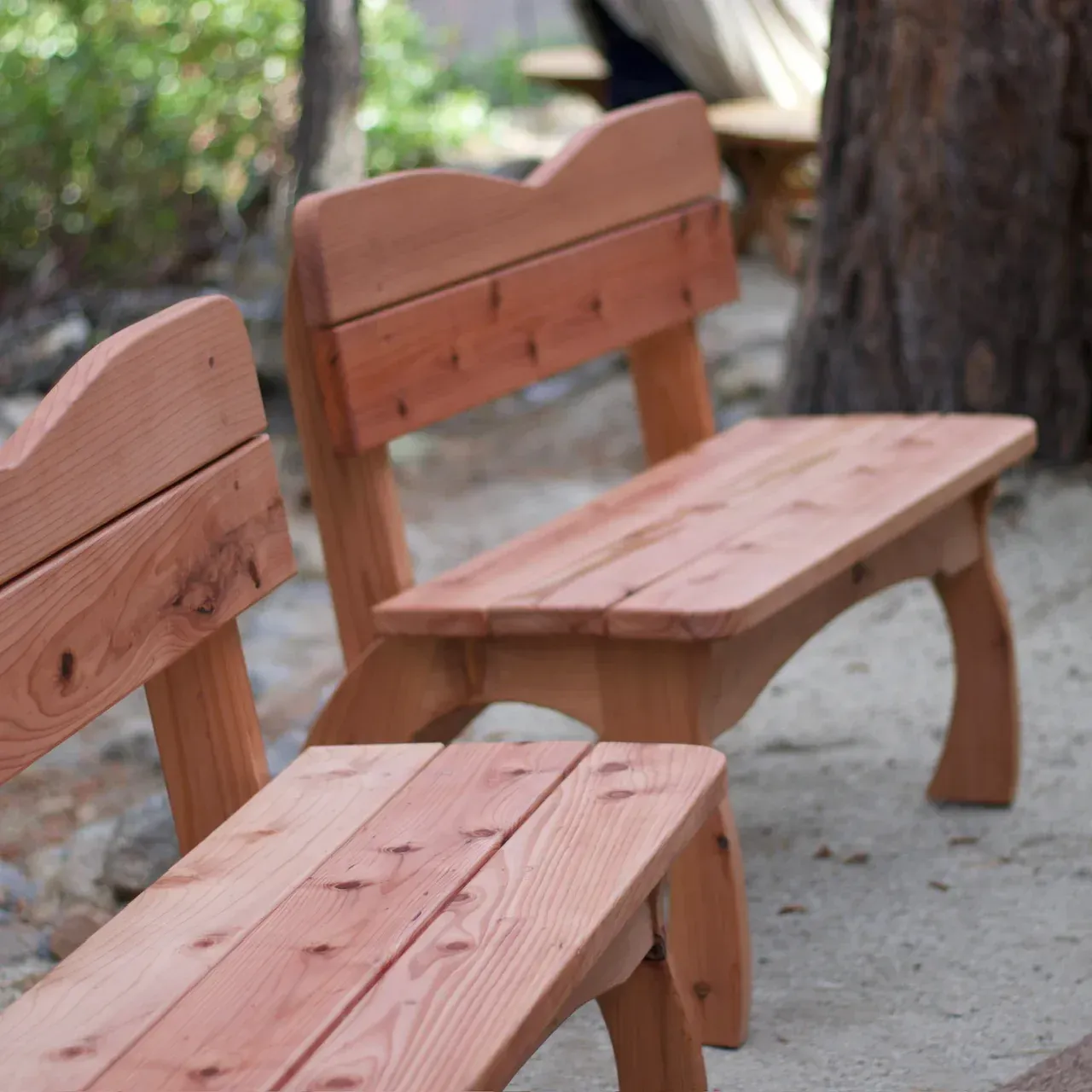 Two wooden benches are sitting next to each other