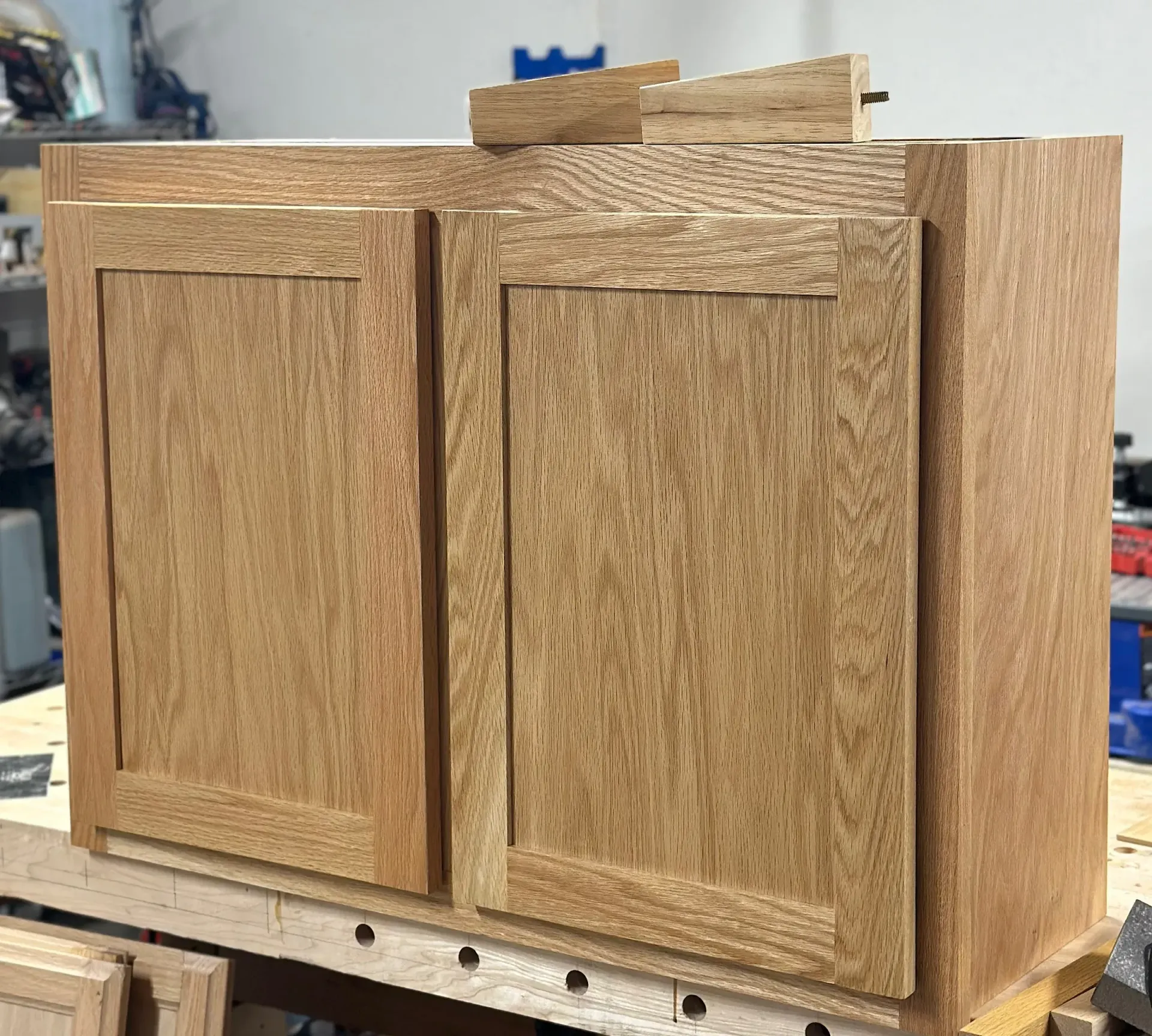 A wooden cabinet is sitting on top of a wooden table.