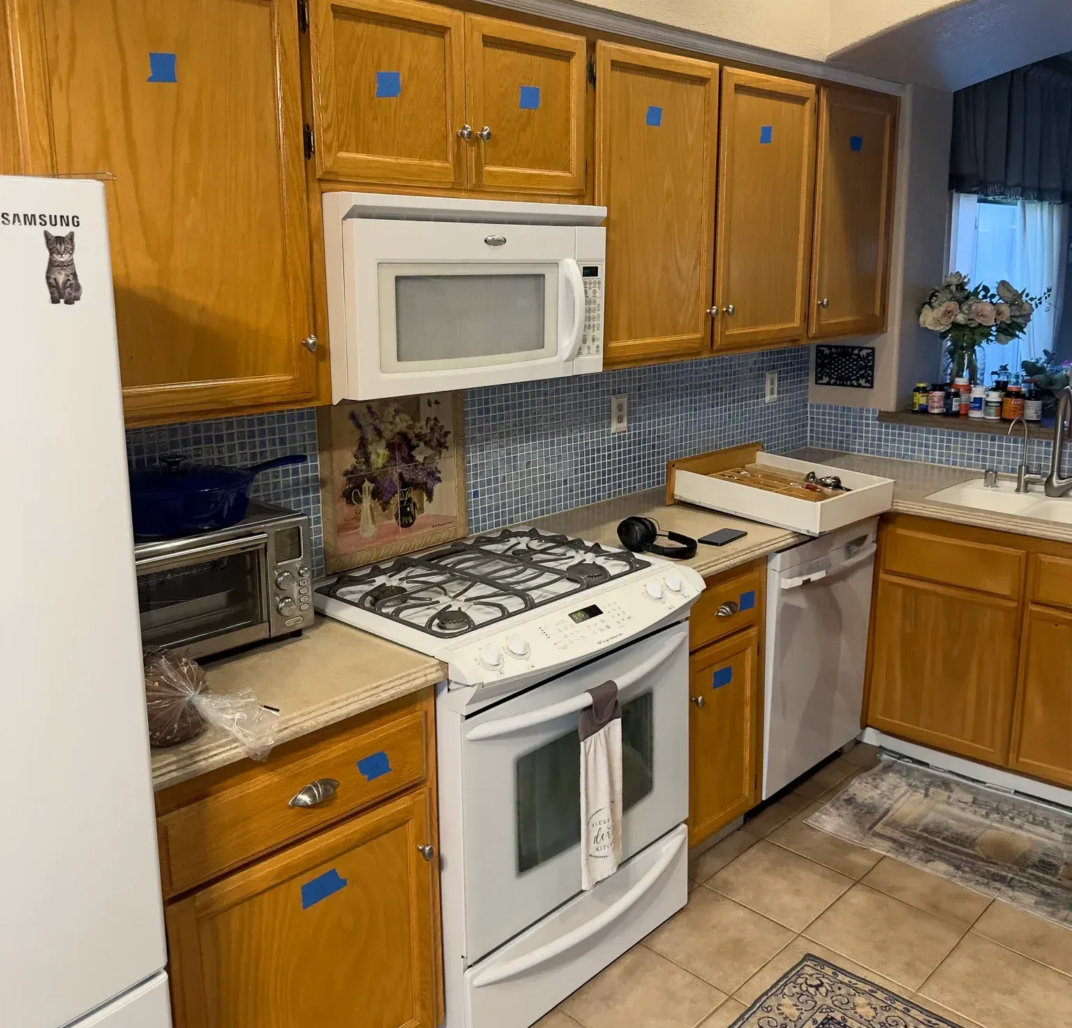 A kitchen with wooden cabinets and a stainless steel dishwasher