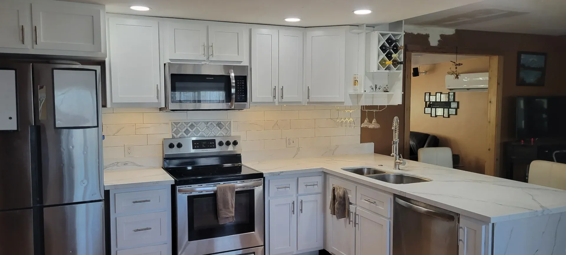 A kitchen with white cabinets and stainless steel appliances.