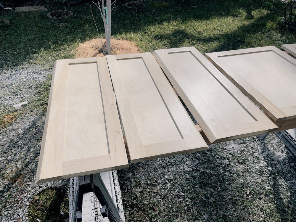Three pieces of wood are sitting on a table outside