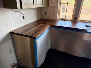A kitchen with black cabinets and a wine cooler.