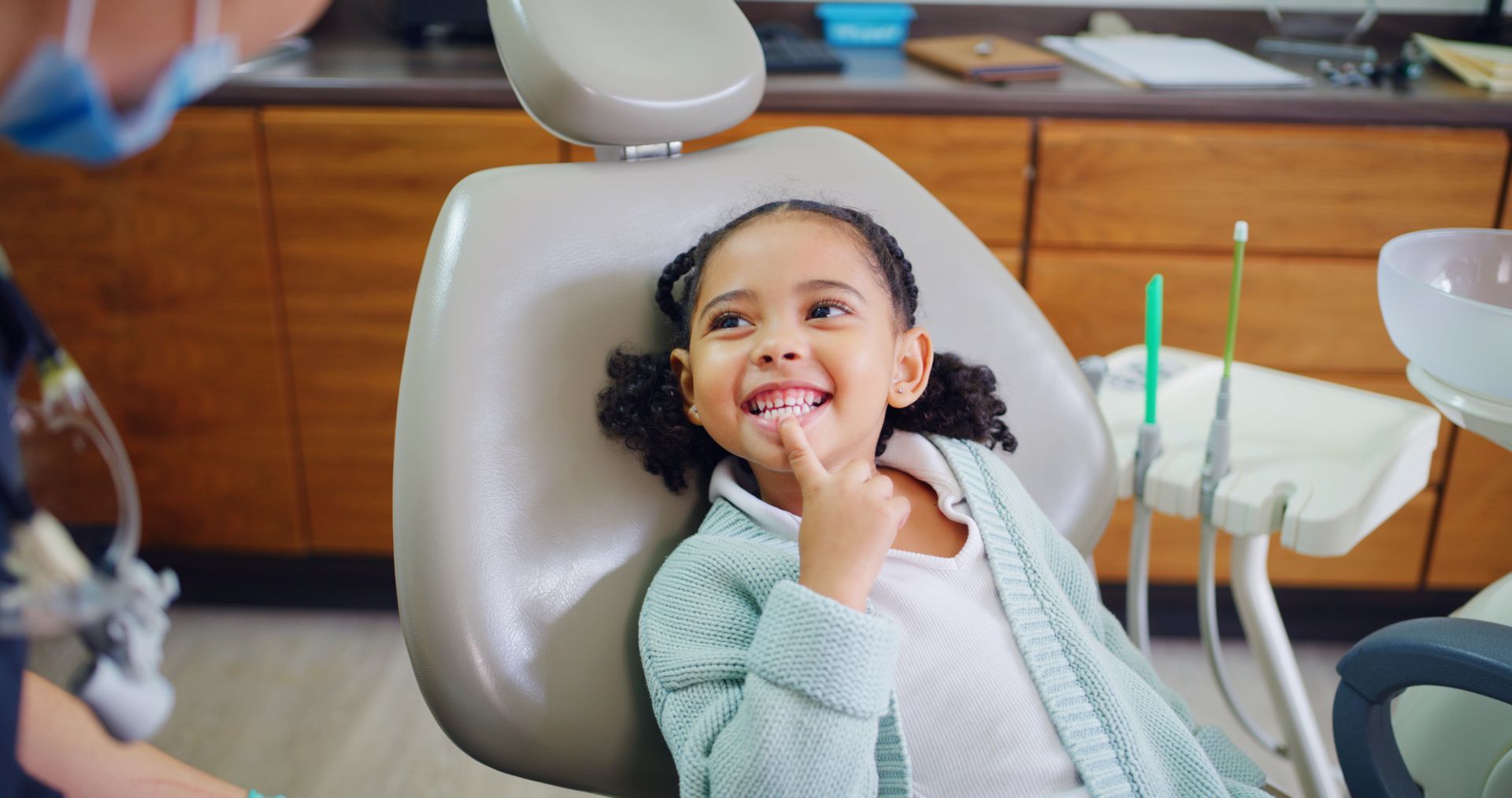 Smiling child having a dental checkup with a pediatric dentist