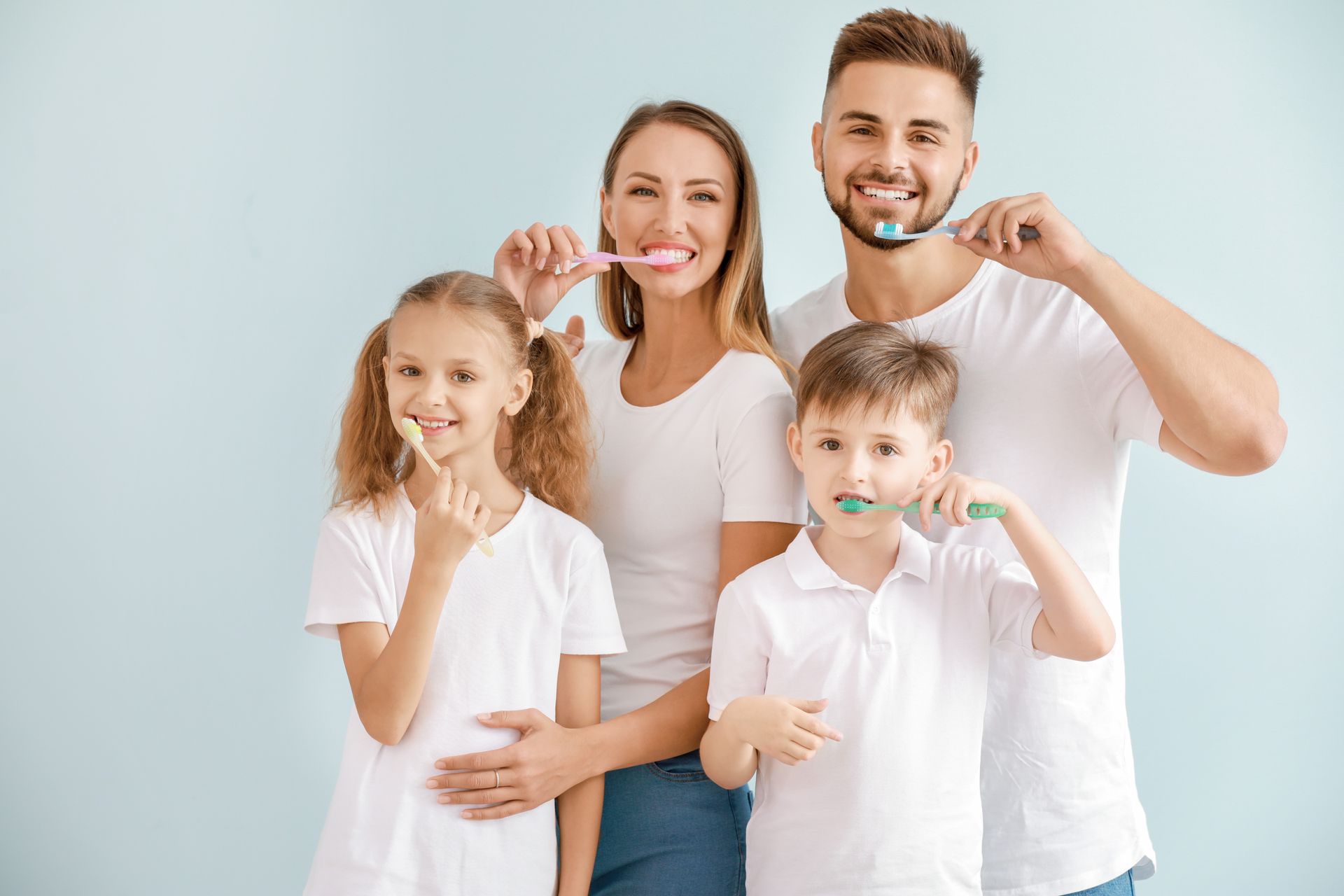 The family brushes teeth together, promoting healthy dental habits. The family brushes teeth together, promoting healthy dental habits.