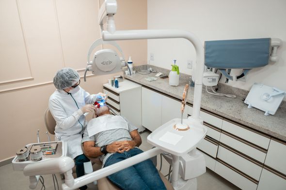Dentist examining the teeth of the patient