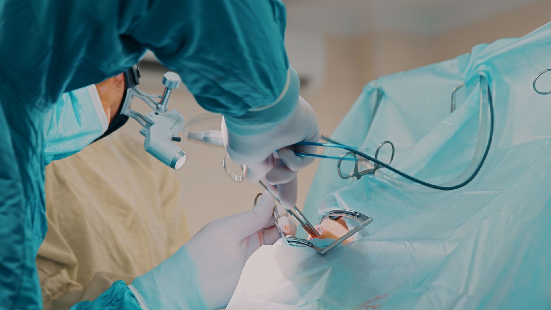 A doctor performs oral surgery using surgical scissors and an electrosurgical pencil at Osage Dental Associates in Blaine, MN