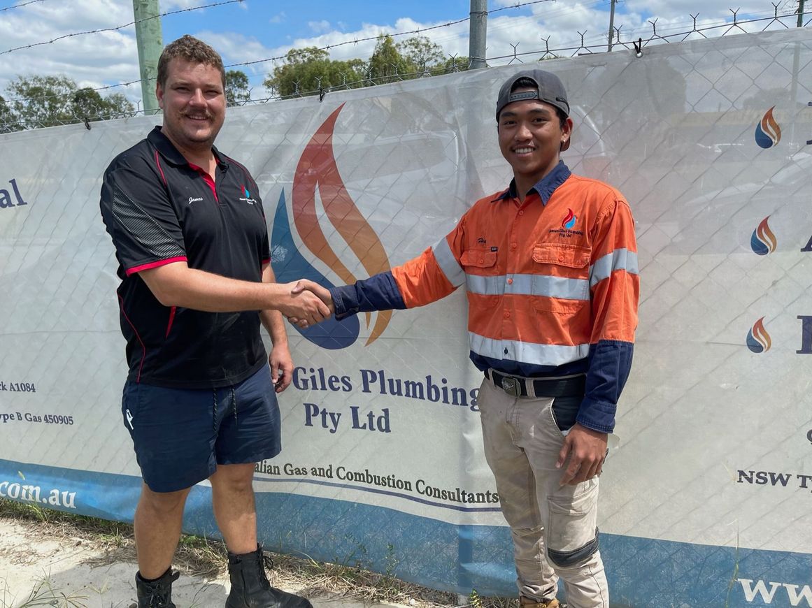 James Giles Plumbing Pty Ltd Director with Apprentice congratulating him on signing up for his plumbing apprenticeship