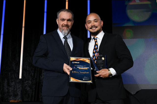 James Giles Plumbing Pty Ltd Employee onstage accepting award for 4th Year Apprentice of Year at the MPAQ Awards in 2024