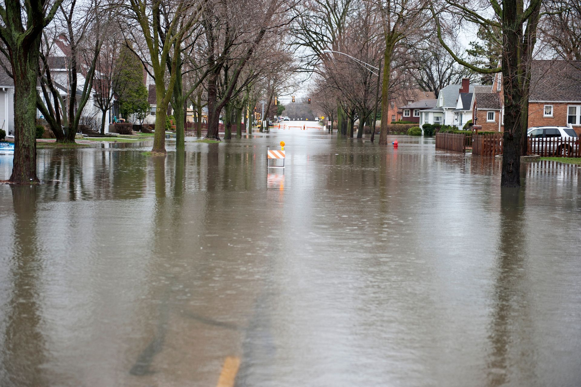 Floodwater covering a residential street after heavy rain