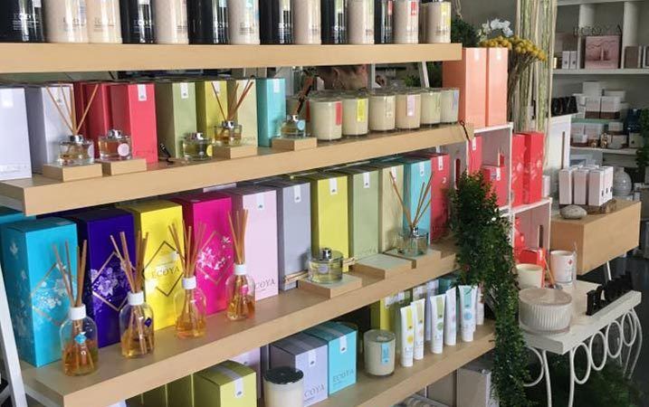 A Shelf Filled With Lots of Candles and Perfumes in a Store — Suncoast Flowers in Birtinya, QLD
