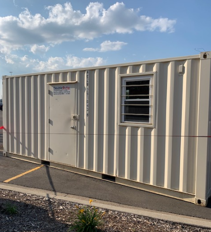 The inside of a shipping container is empty and looks like a tunnel.