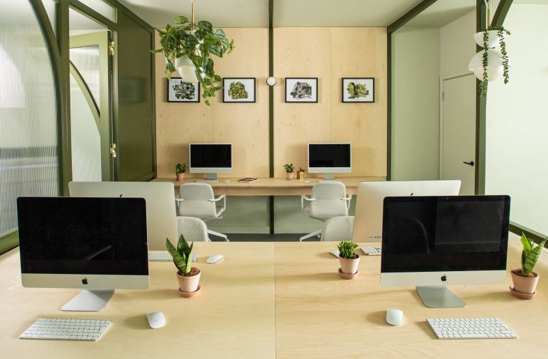 Office cleaning staff sanitising desks and workstations in South Woodford office