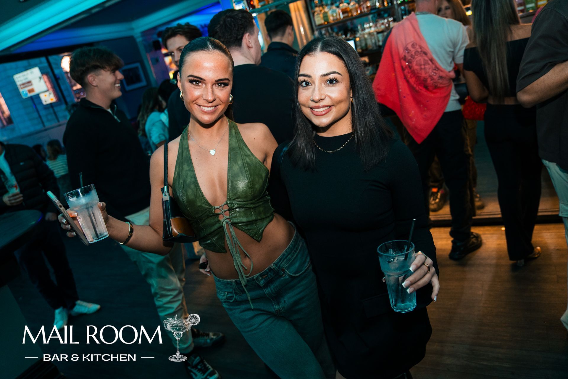 Two women are posing for a picture at a party.