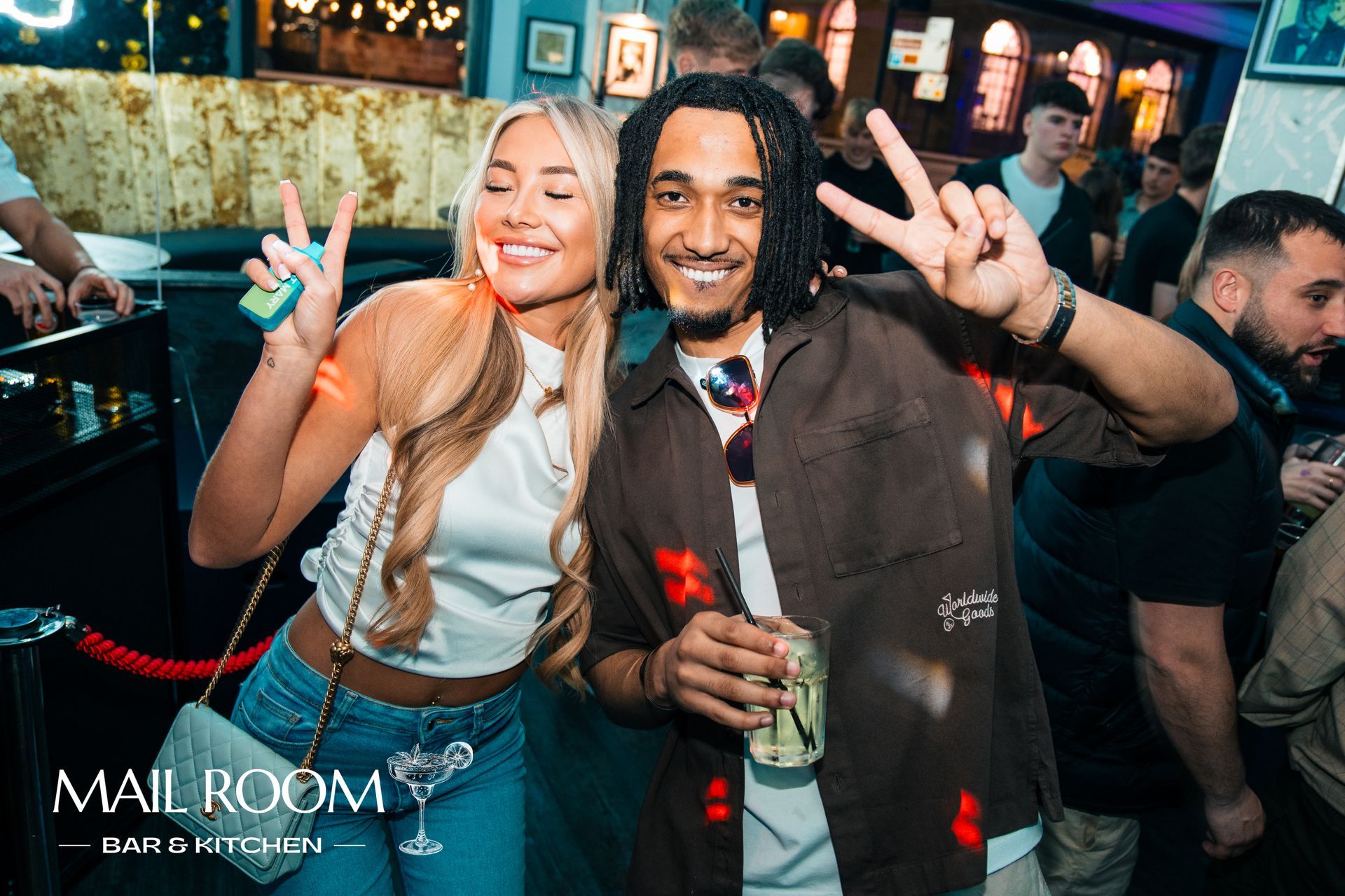 A man and a woman are posing for a picture at a party.