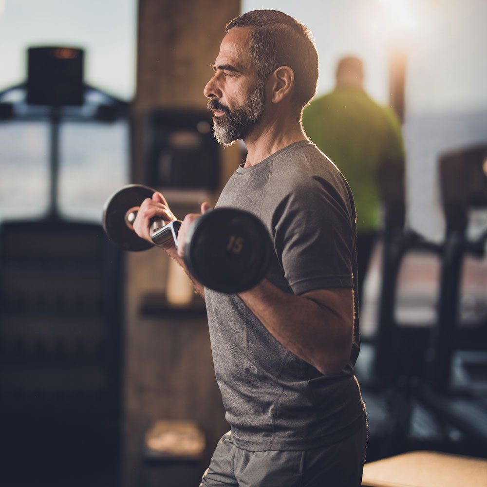 Man Doing Weight Exercise — North East, MD — Euro Gym