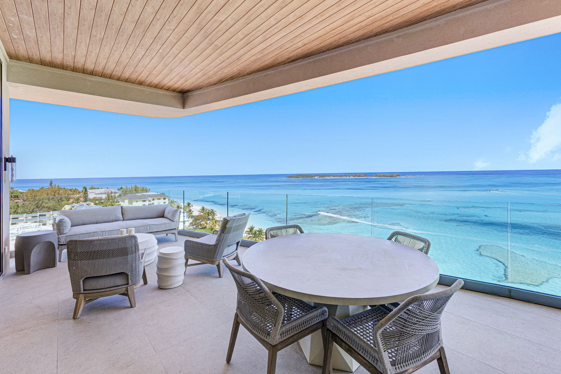 A luxury dining room with a table and chairs and a bookshelf in Aqualina, Bond Vacations, Nassau Bahamas