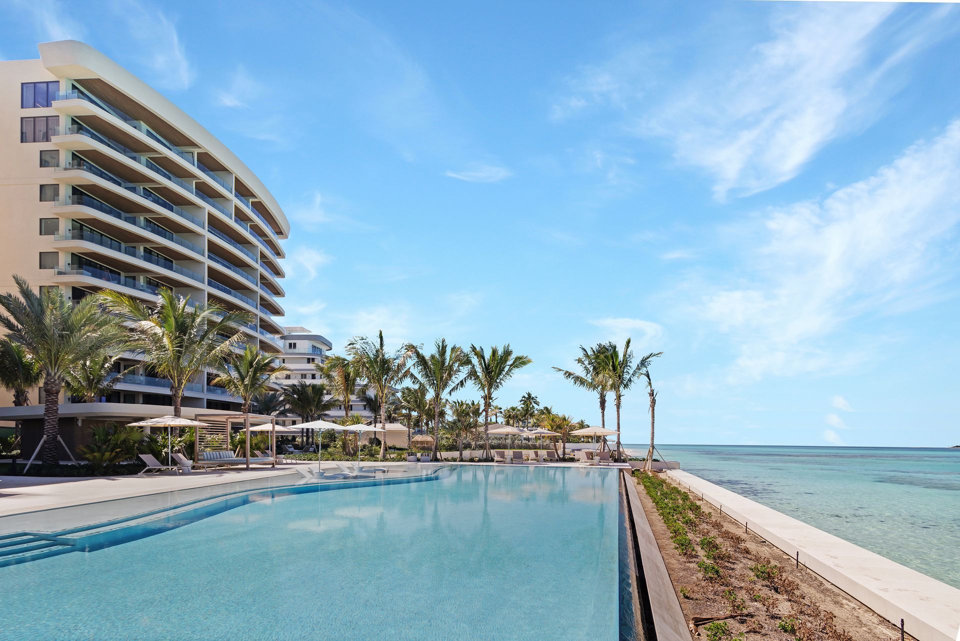Beachfront facade of Aqualina with oceanview pool in Nassau, The Bahamas