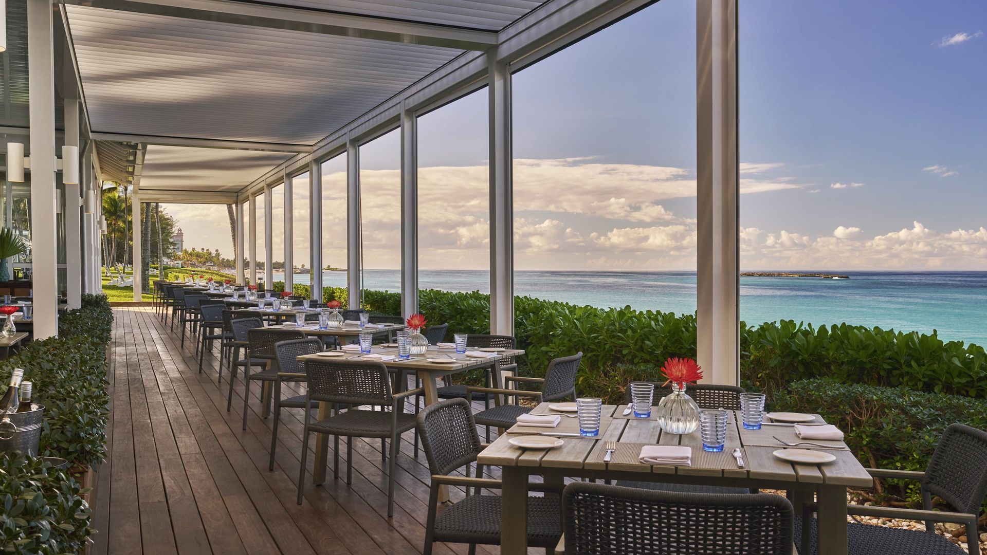 Cafe Matisse view with tables and chairs overlooking the ocean in Nassau, 