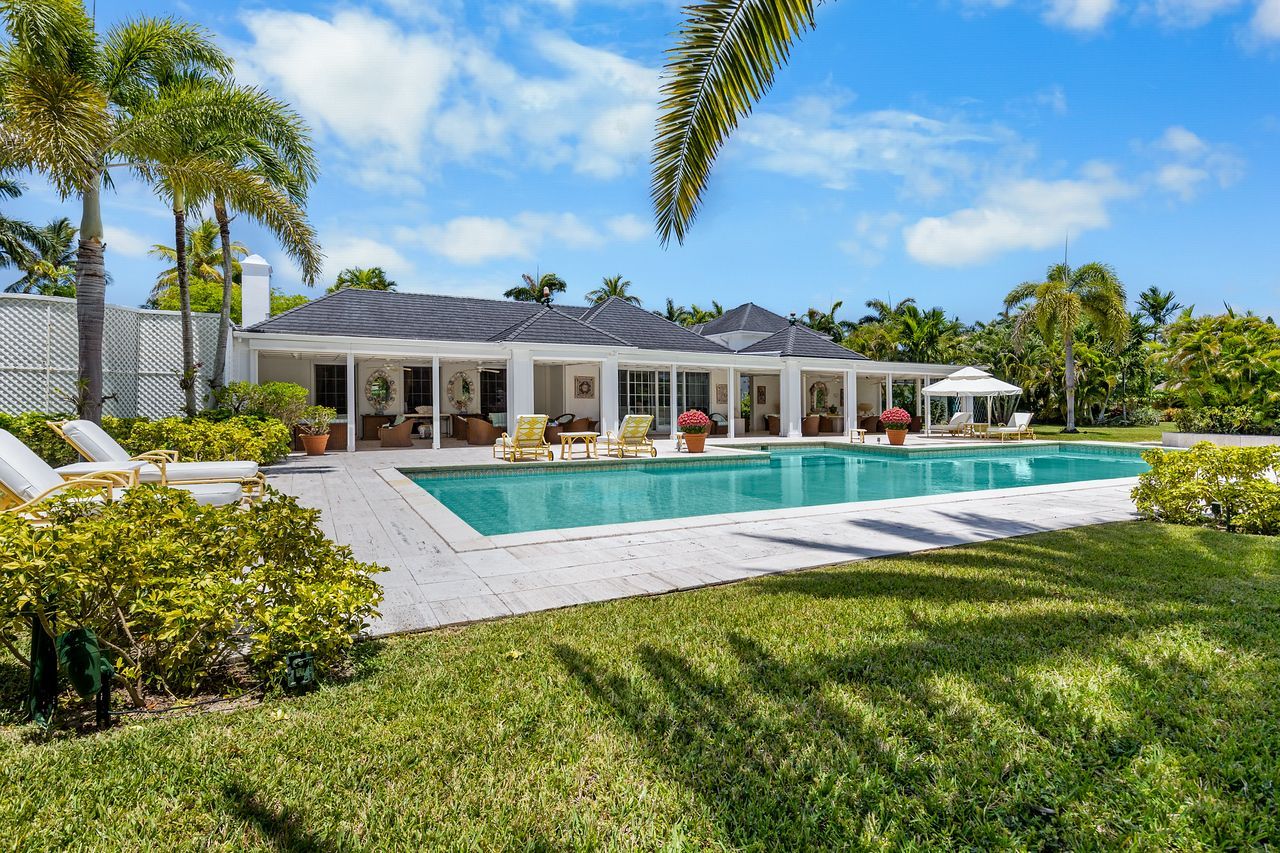 One cable beach property  with a swimming pool in front of it in Nassau Bahamas