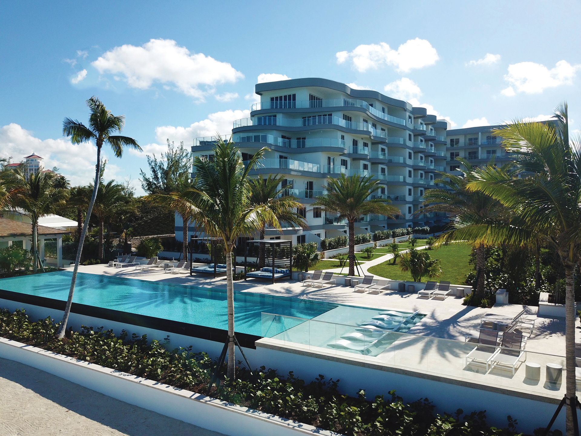 One cable beach property  with a swimming pool in front of it in Nassau Bahamas