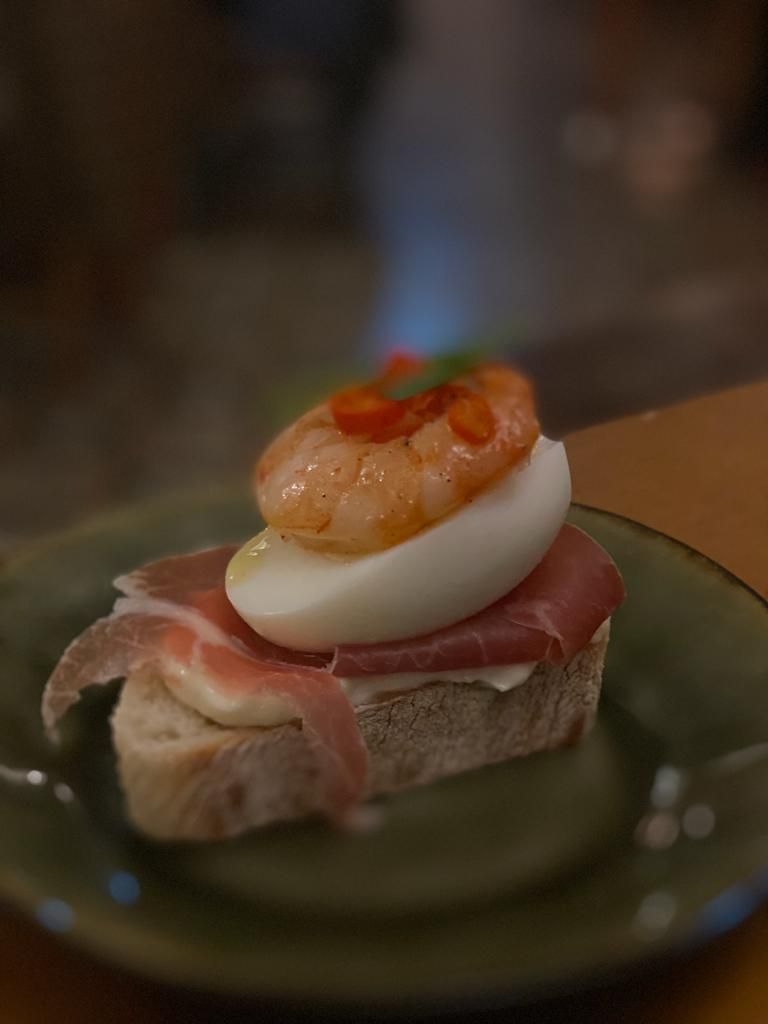 a close up of a plate of food with shrimp on top
