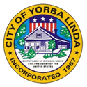 Seal of Yorba Linda, California: circular with a house, flag, stars, and text