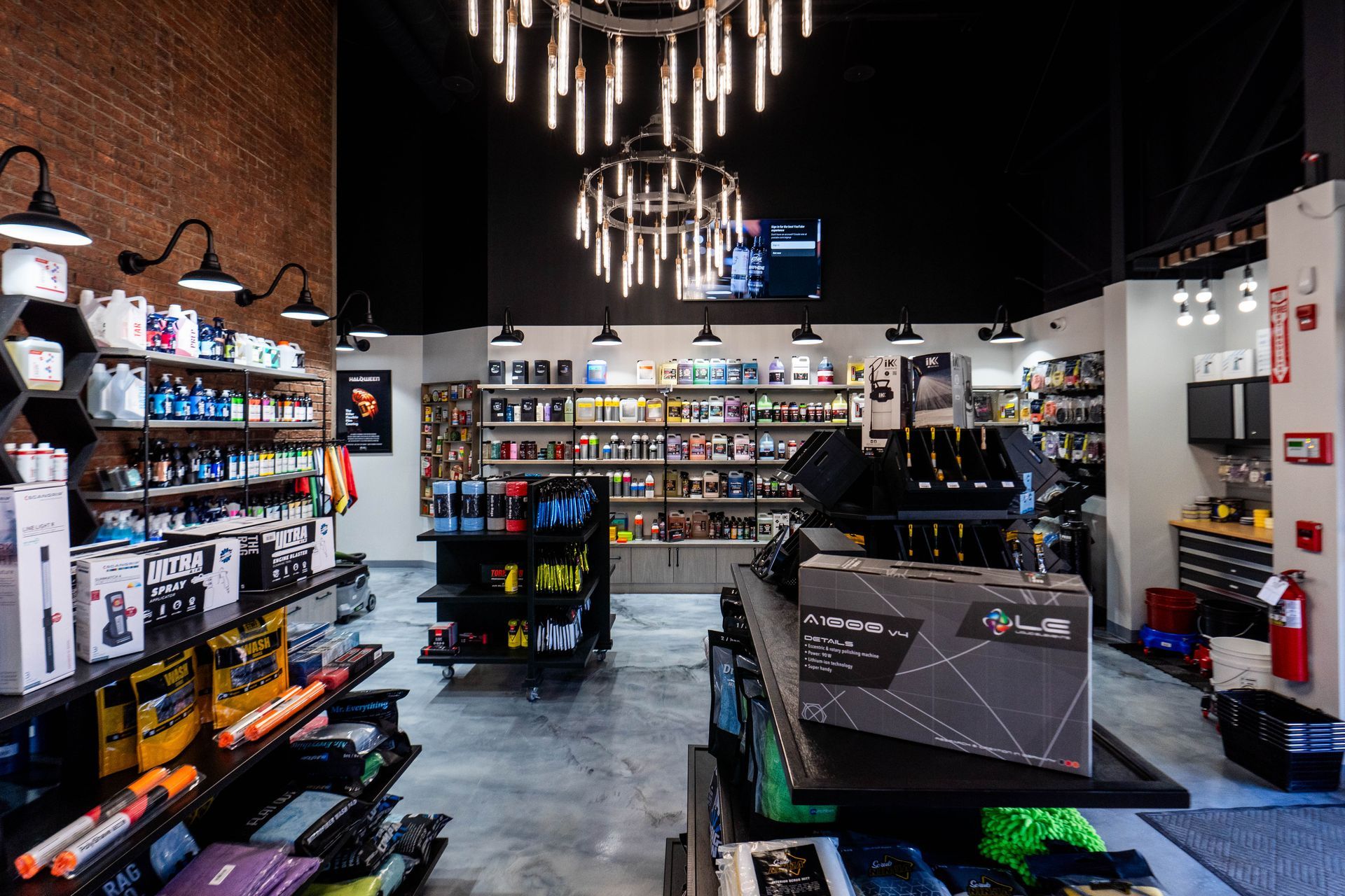 A store filled with lots of shelves and a chandelier.