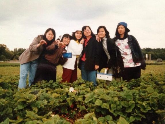 A group of women are posing for a picture in a field