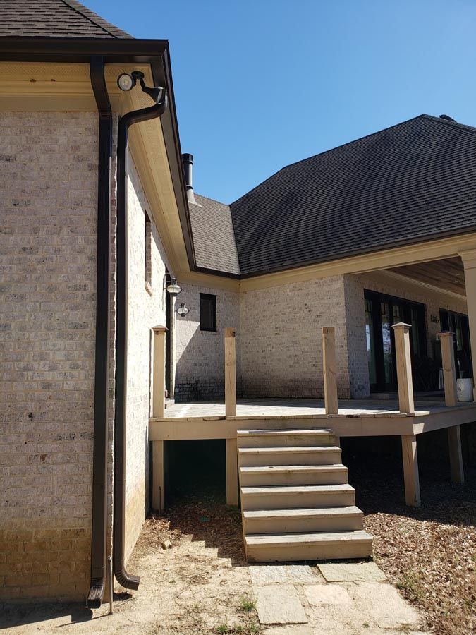 A house with a deck and stairs leading to it