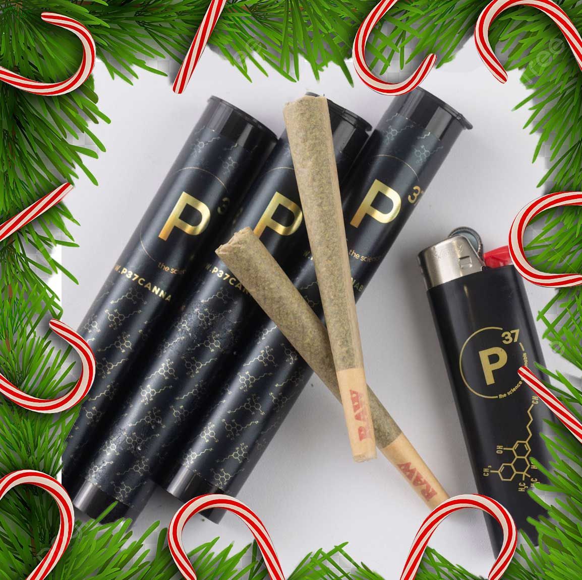 Pre-rolled cannabis joints and lighter with holiday decorations.