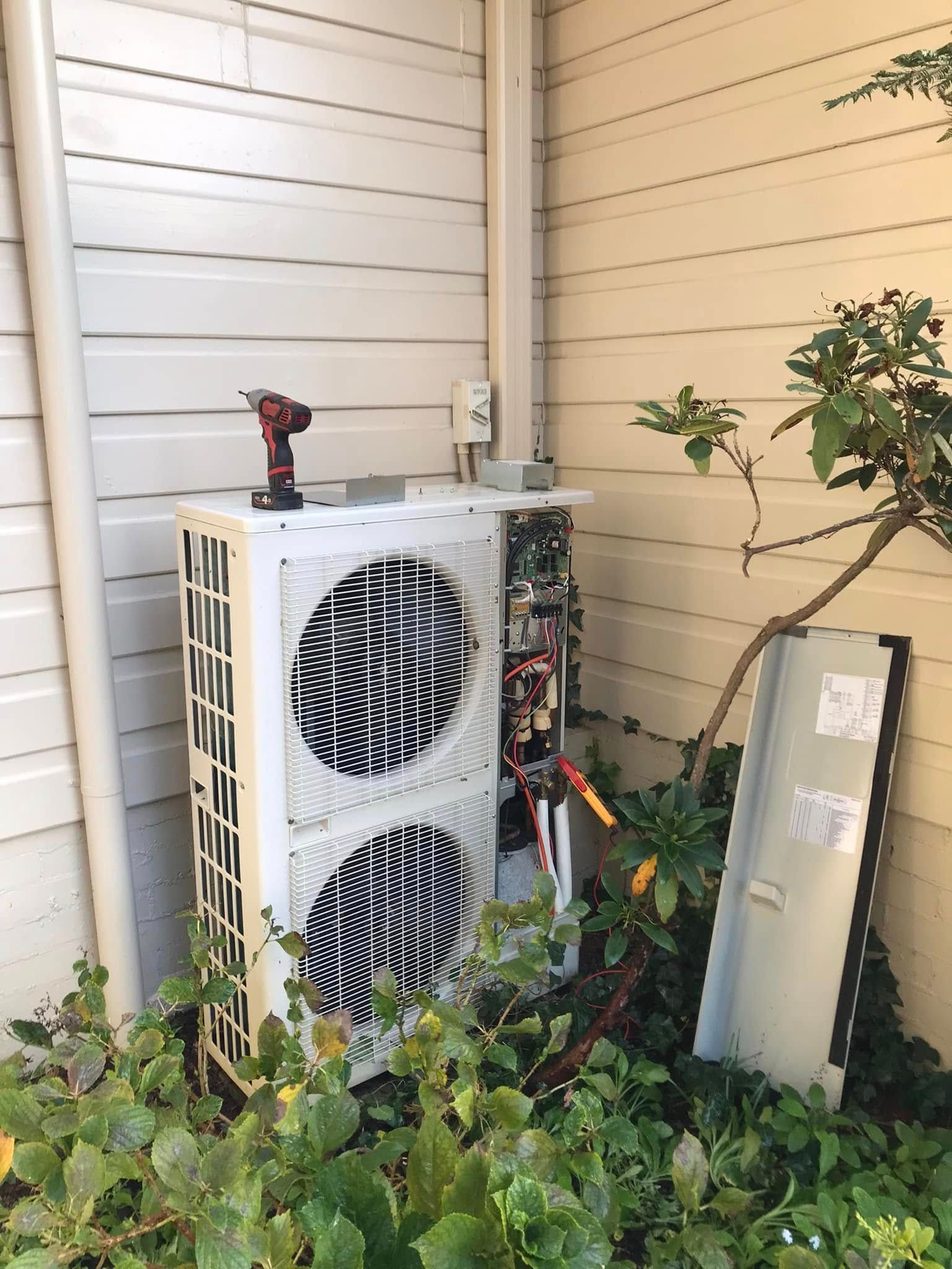 HVAC Unit Being Serviced Outdoors — Escarpment Air in Mount Saint Thomas, NSW