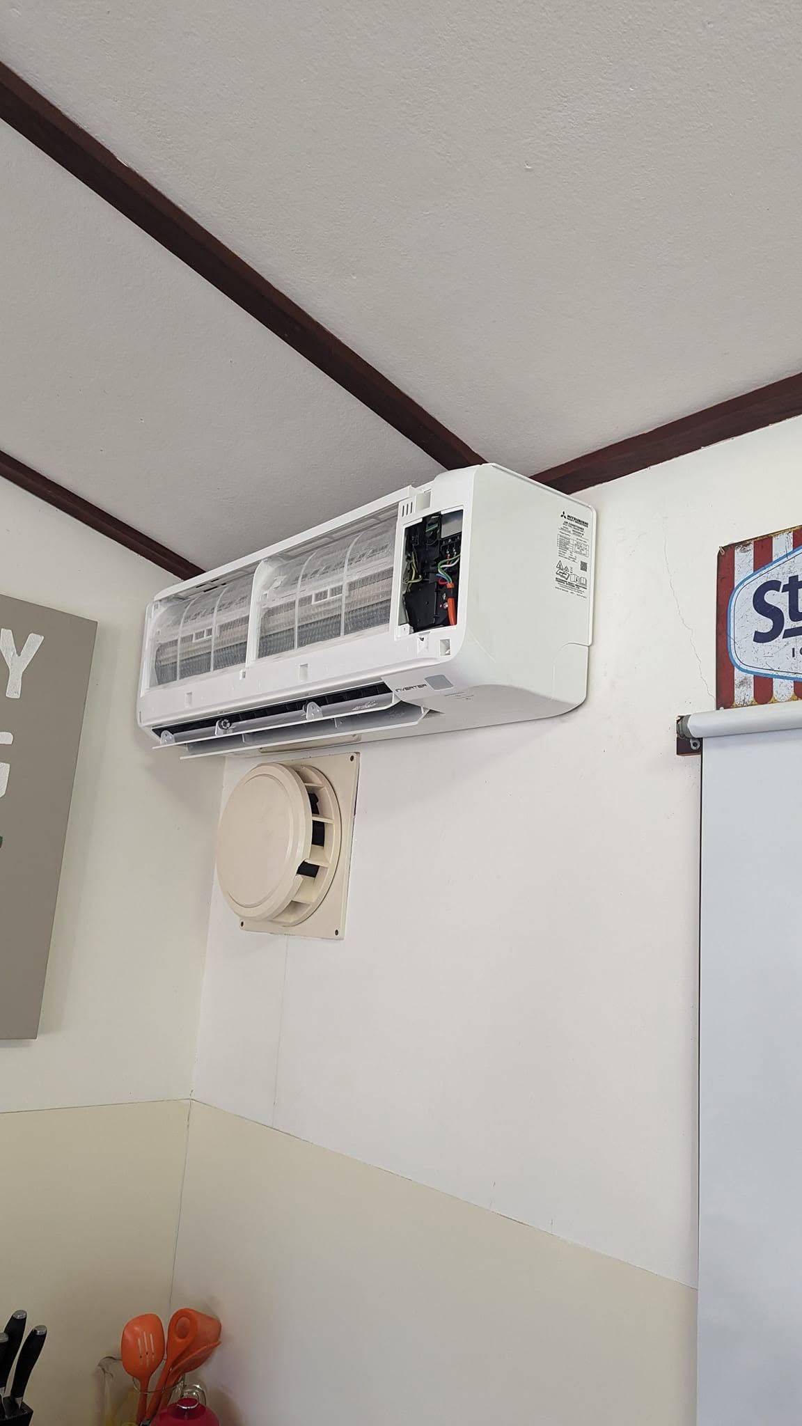 Wall-mounted Air Conditioner Above A Doorway — Escarpment Air in Campbelltown, NSW