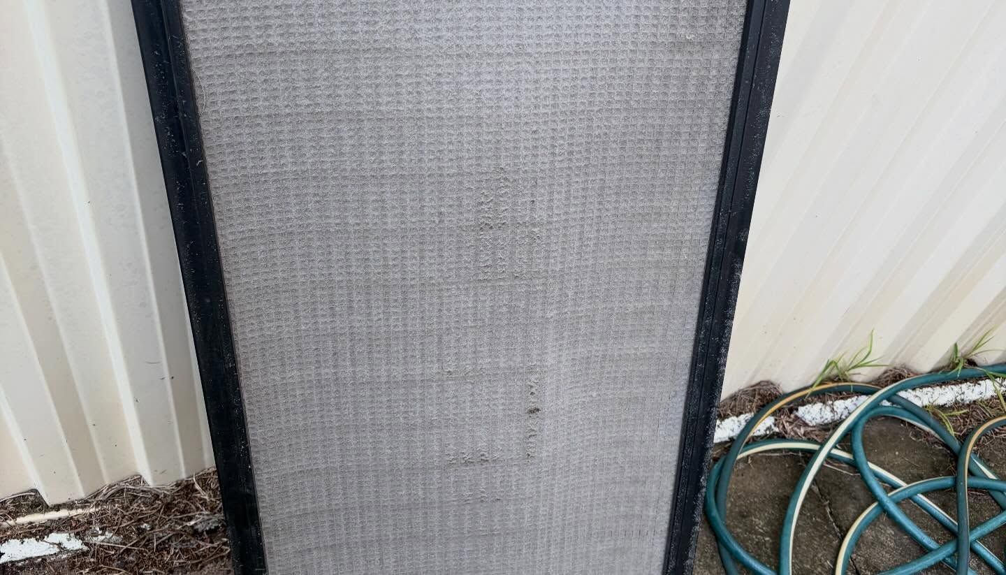 Gray Mesh Screen Panel Leaning Against A White Fence — Escarpment Air in Mount Saint Thomas, NSW