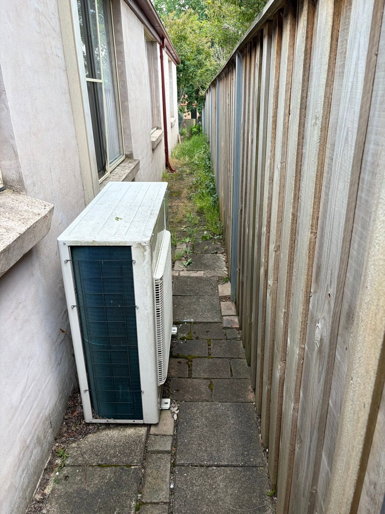 Narrow Side Passage Beside A House, With An Outdoor AC Unit — Escarpment Air in Mount Saint Thomas, NSW