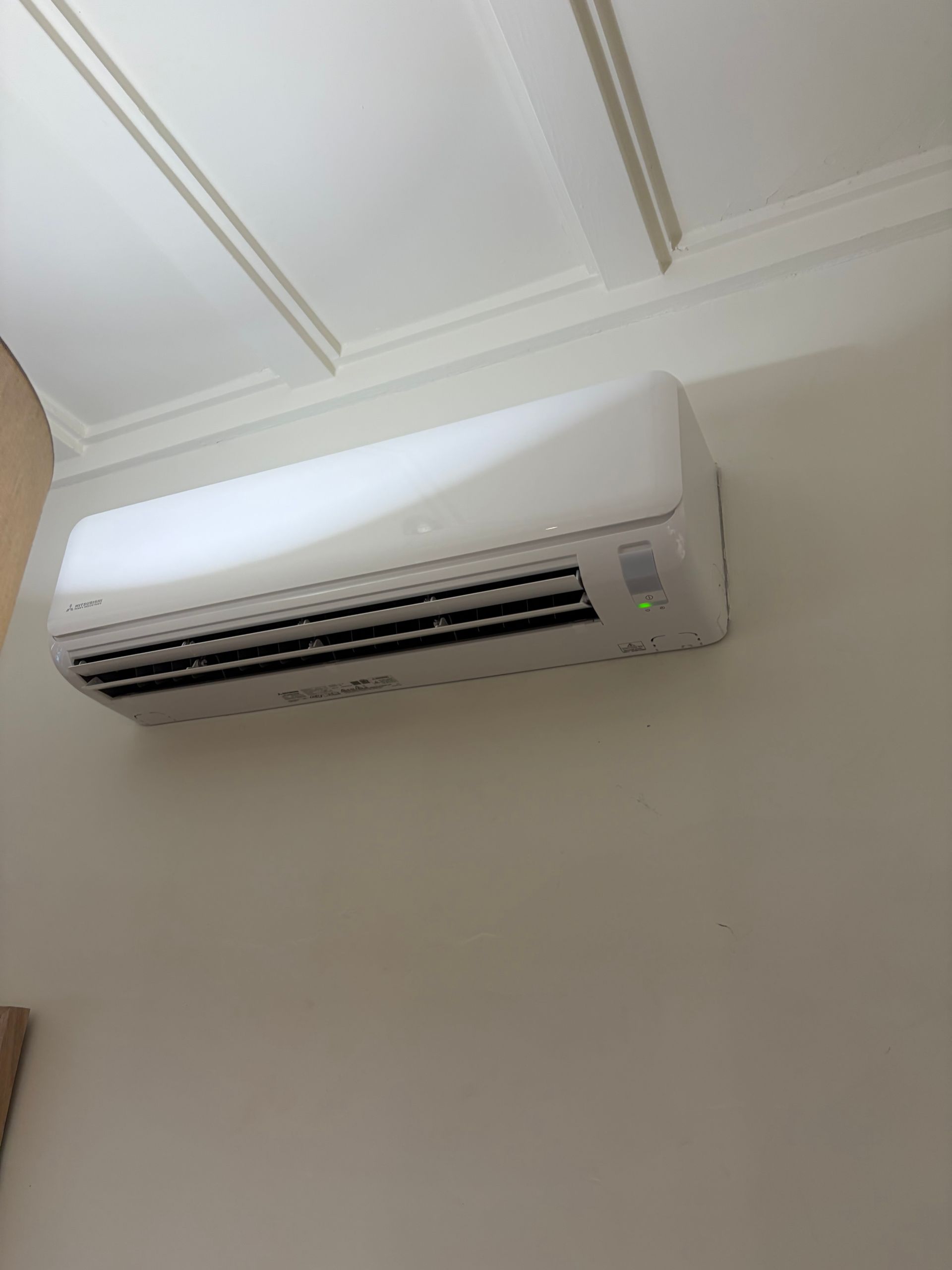 White wall-mounted air conditioner on a cream ceiling and wall — Escarpment Air in Mount Saint Thomas, NSW